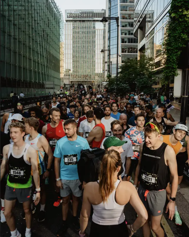 Runners packed onto the closed-road start line between the towers at Run The Wharf